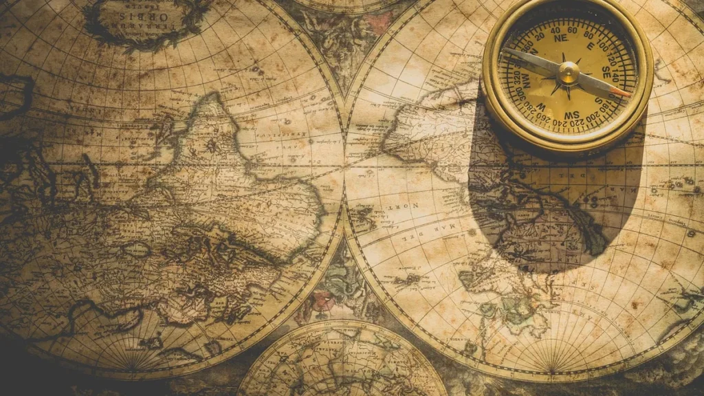 A brass compass rests on a vintage world map, symbolizing direction, exploration, and mapping new paths.