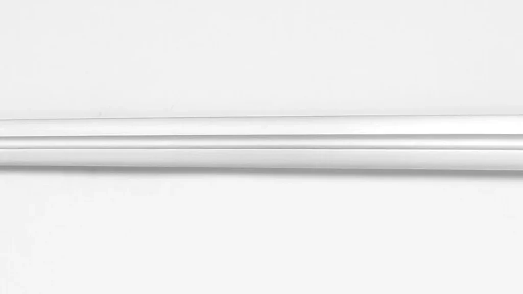 A close-up horizontal view of a silver metallic blade with a central groove against a plain light background.