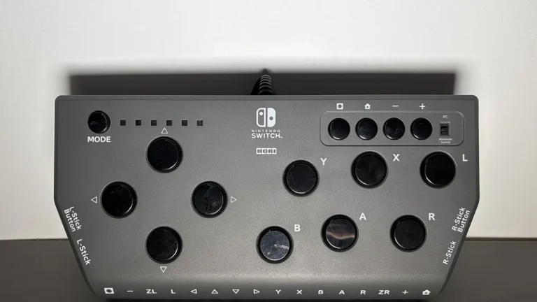 Grey Hori leverless controller for Nintendo Switch, featuring a button-heavy fighting layout on a clean grey surface.