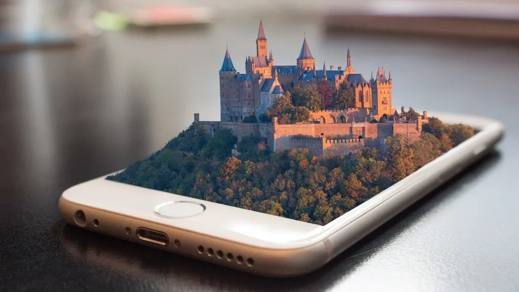 A gold smartphone displaying a 3D pop-out of a medieval castle on a forested hill.