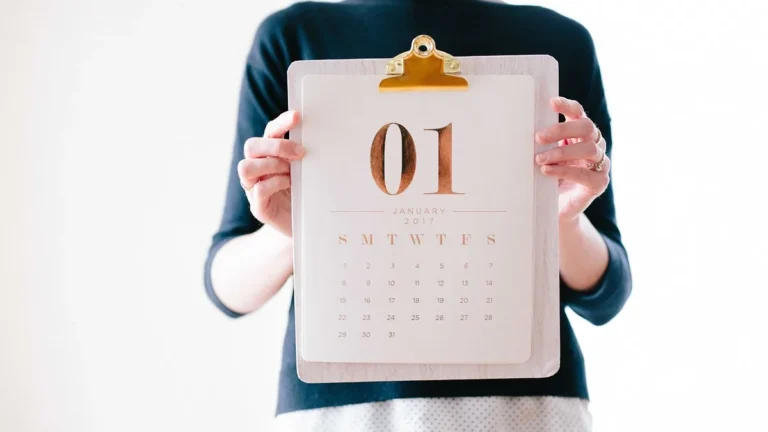 A person holding a clipboard with a minimalist calendar showing January 1, 2017.
