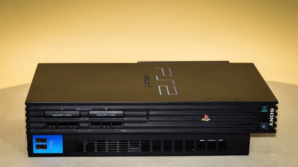 Black Sony PlayStation 2 console displayed horizontally, showing front ports and colorful PlayStation logo.