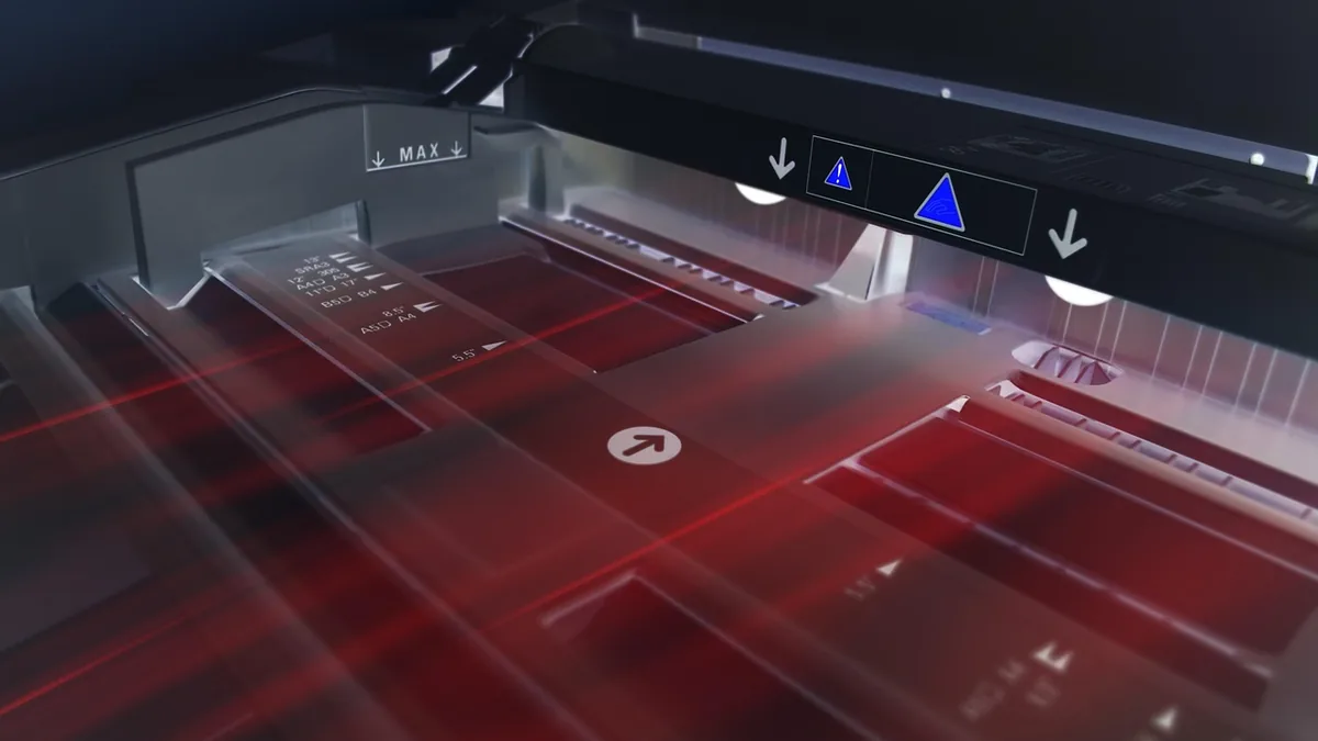Red laser lines scan a printer tray with size markings, symbolizing automated copying and technology-assisted creation.
