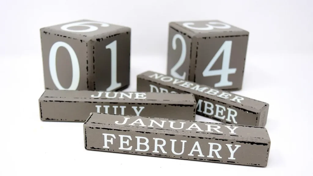 Gray wooden calendar blocks showing the month of November and date numbers on a clean white background.