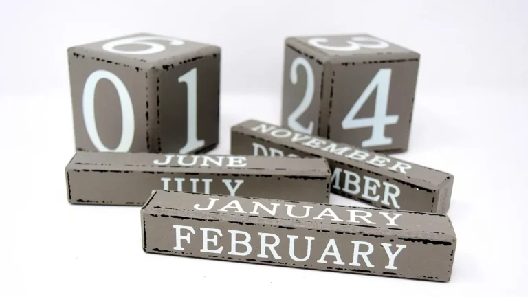 Gray wooden calendar blocks showing the month of November and date numbers on a clean white background.