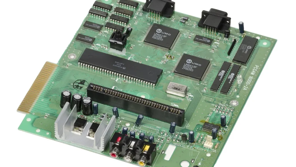 A green gaming console circuit board with various microchips, ports, and components.