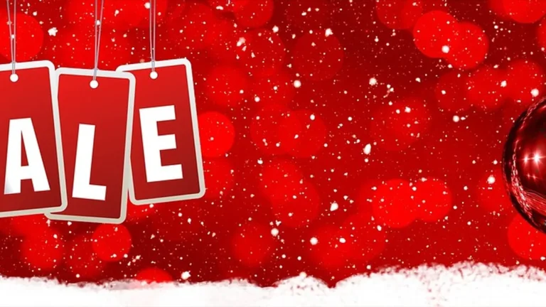 Red festive background with hanging red tags spelling 'SALE' in white, decorated with white snow-like sparkles and a red