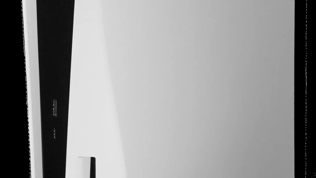 Close-up of a white and black PlayStation 5 console showing the USB port panel on the side.