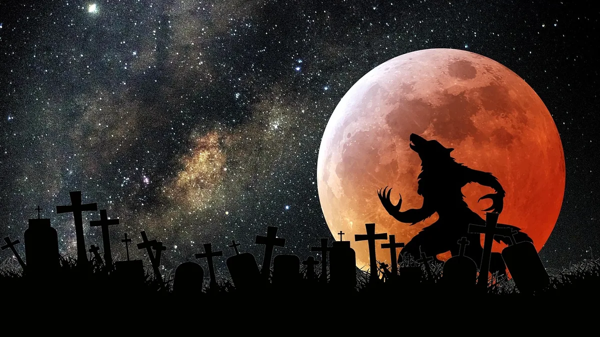 Silhouette of a werewolf howling in a graveyard against a giant red moon and starry sky.