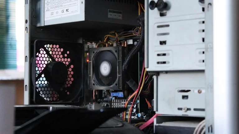 Interior view of a desktop PC tower showing cooling fans, motherboard, and colorful cables.