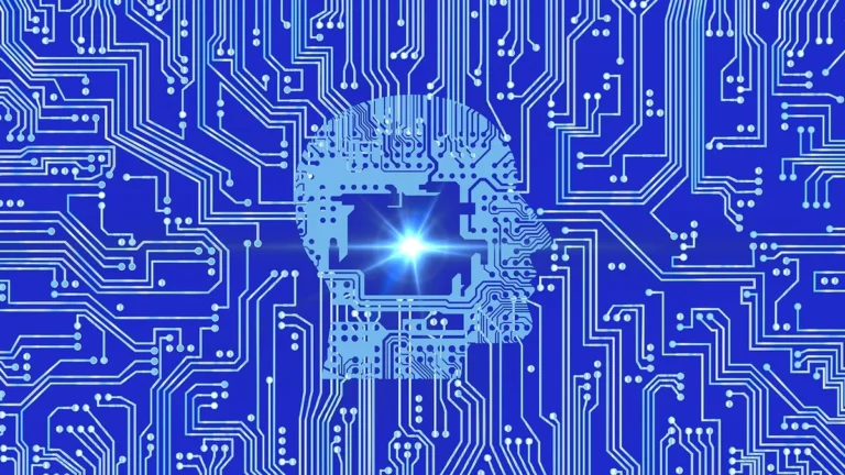 A blue circuit board pattern with a glowing human head silhouette representing artificial intelligence.