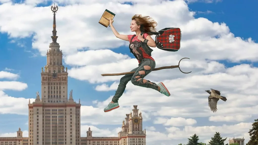 A woman flying on a broomstick holding a book, wearing a red backpack, with a grand tower in the background.