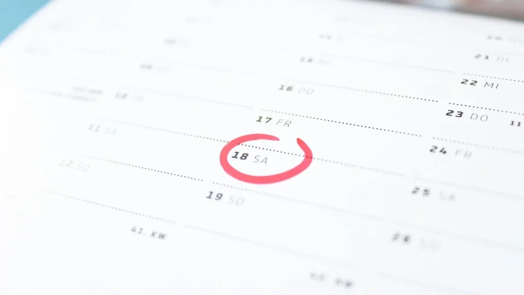 A close-up of a calendar page with the date Saturday the 18th circled in red marker.