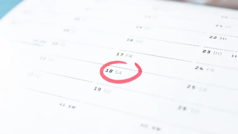 A close-up of a calendar page with the date Saturday the 18th circled in red marker.
