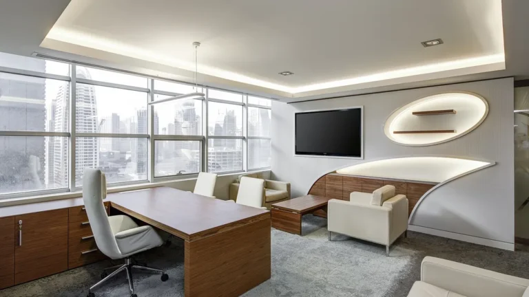 Spacious modern executive office with wooden desk, white chairs, and city skyline view.
