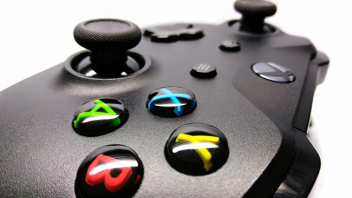 Close-up of a black Xbox controller showcasing colorful A, B, X, and Y buttons.
