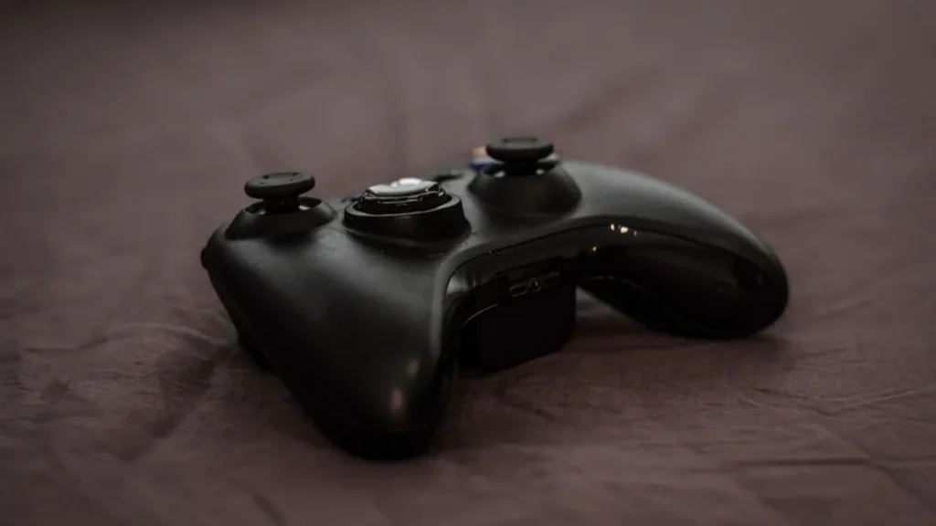 Close-up of a black Xbox controller on a dark surface