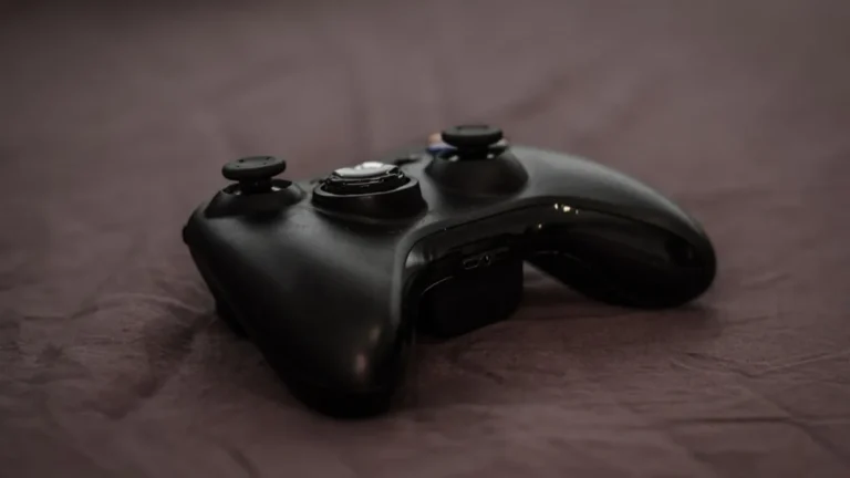 Close-up of a black Xbox controller on a dark surface