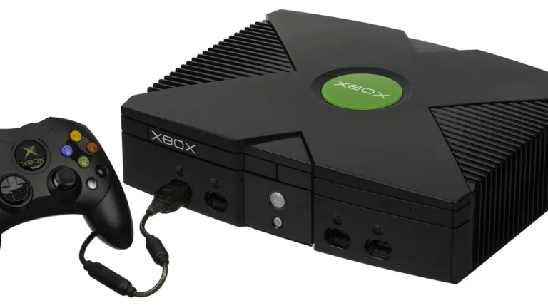Black original Xbox console and controller, showing the iconic green Xbox logo on the top center.